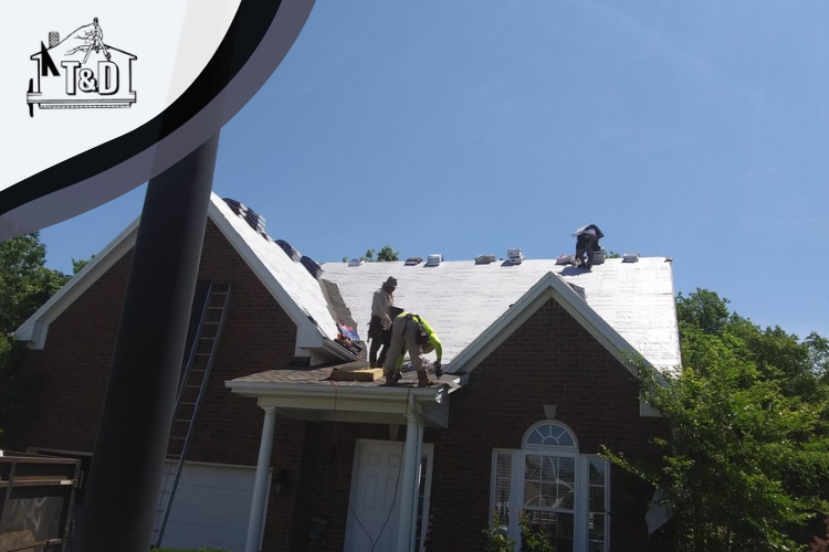 A team of roofers repairing and replacing the roof on a home in Gallatin, TN.