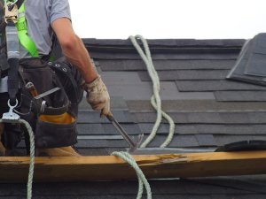 Roofing professionals securing loose shingles to ensure resilience against upcoming late summer storms in Cottontown, TN.