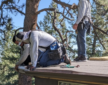 Roofing team installing seamless gutters in Cottontown