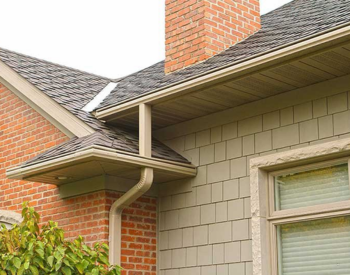 Close-up of seamless gutters installed by T & D Construction