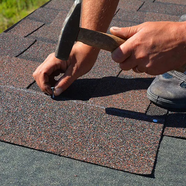 T & D Construction crew installing asphalt shingles on a residential roof